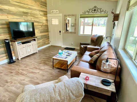 Spacious living area with smart TV and comfortable seating