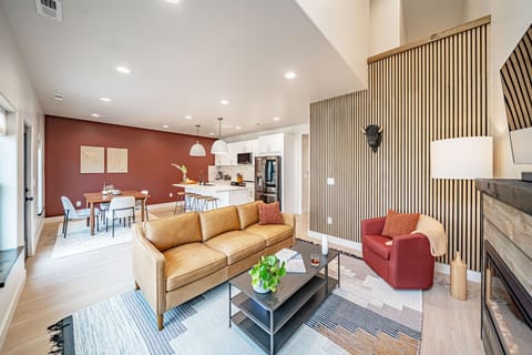 This pristine space is equipped with a leather couch & a cozy fireplace.