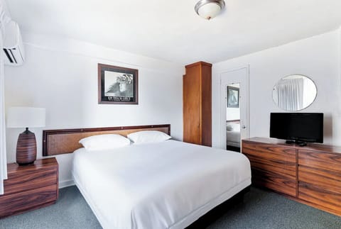 Sink into crisp linens in this calm, spacious bedroom.
