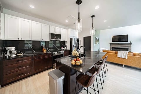 Fully equipped kitchen with brand new cookware set, knives, and coffee machine.
