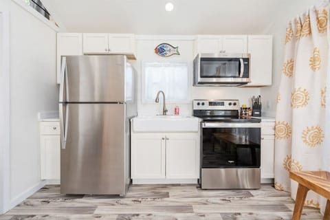 Custom cabinets, full size stainless appliances and a farmhouse sink will have you saying is this really a tiny house?