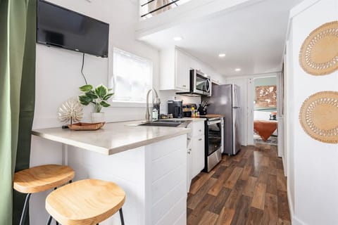Kitchenette: Whip up culinary delights in a stylish nook with modern appliances and vibrant decor!