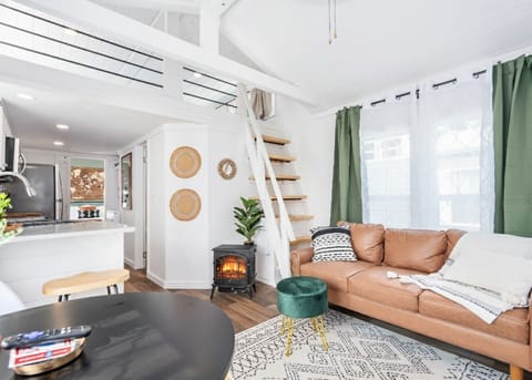 Living Room: Bright and airy space with stylish decor, perfect for warming up by the fireplace!