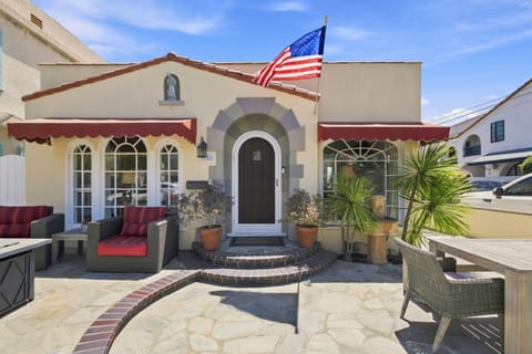 Charming Spanish-style home with sunny patio seating and outdoor dining