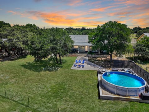 Aerial view of the backy yard showing fire pit and private pool.