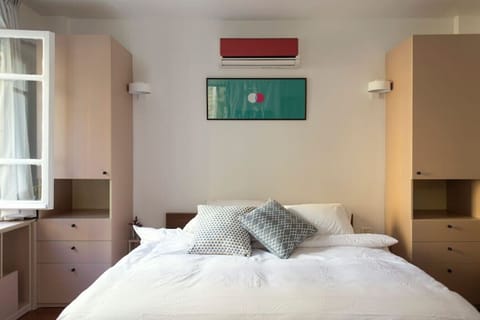 A cozy bed space wrapped in soft natural light