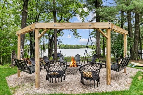 Cozy up by the firepit on swings with a breathtaking view of the lake—perfect for relaxing evenings and making memories.