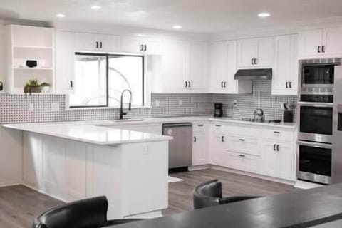 Pristine kitchen with plenty of built-in cabinets and quartz countertops