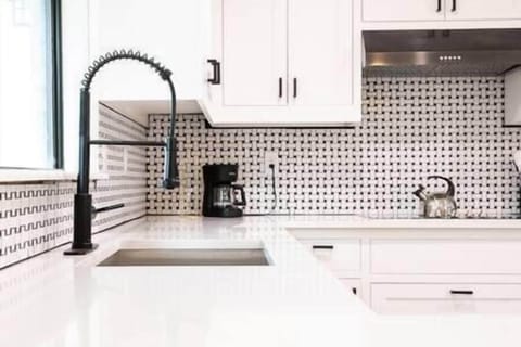 Farm house sink with quartz counters and beautiful backsplash tile!