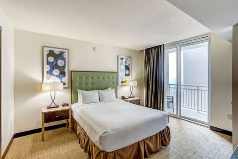 Drift into crisp linens beside balcony doors and fresh air.