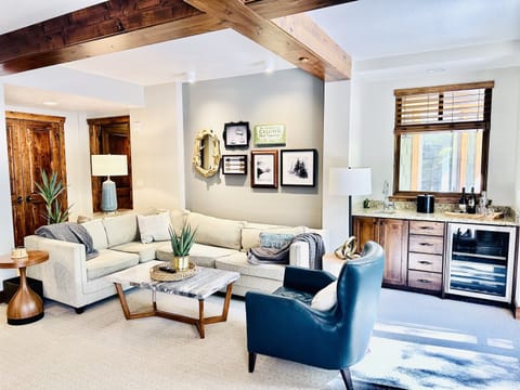 Stylish living room with fireplace, bar area and dining for 10.  Open floorpan is great for gathering and relaxing.