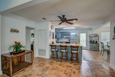 Open area full kitchen with bar stool seating. Dog crate provided.