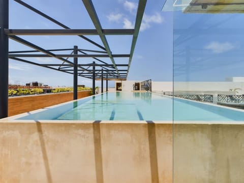 Relax in a serene rooftop pool under the open sky. ✨