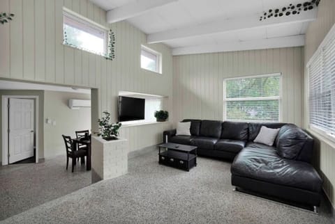 1st Living Room with large sofa, HDTV, & office space for mobile professionals.