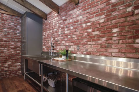Stainless steel commercial countertop against a brick wall!