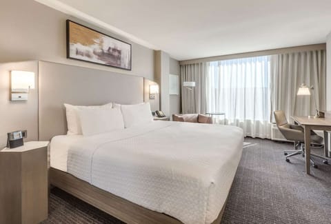 Drift off in crisp linens under warm bedside lighting.