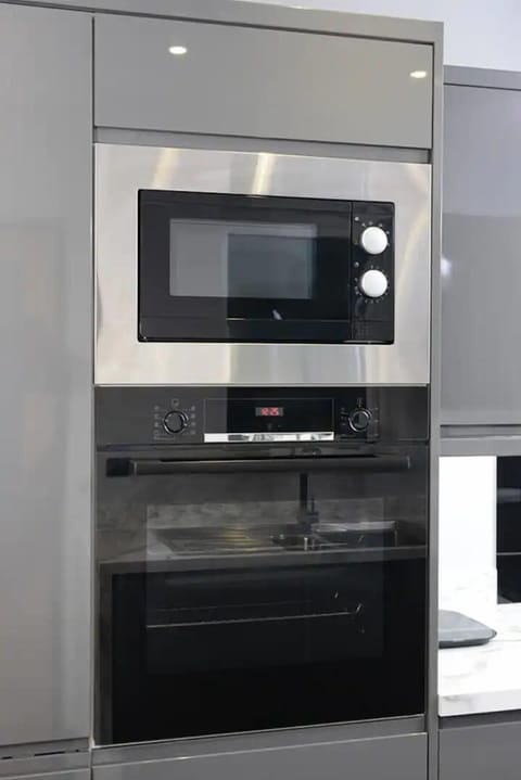 Equipped with oven and microwave for your convenience, ensuring easy meal preparation during your stay.