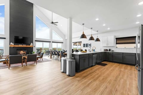 Extremely open kitchen/dining/living room area with vaulted ceilings.