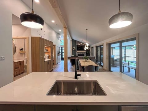 The kitchen island features a large sink, dishwasher, and seating for 4 with usb charging.