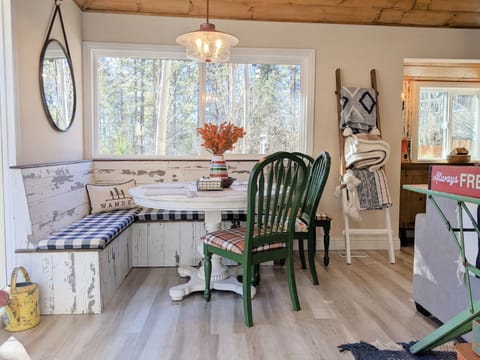 The rustic-camp-themed dining area has a corner bench and chairs so the whole family can gather around for family meals.