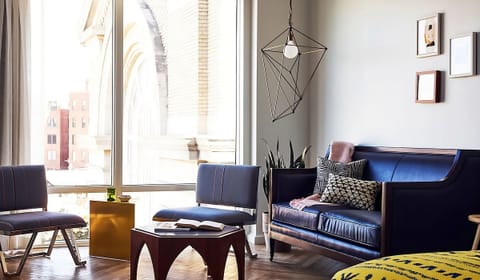 Lounge by soaring windows and watch the city glow.