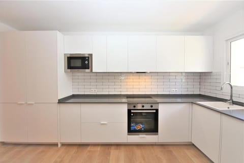 Modern open kitchen is fully fitted with quality appliances