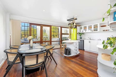 Enjoy the convenience of an open kitchen featuring ample cabinet space and a practical island. This inviting area seamlessly connects to a dining space with a table and chairs that comfortably seat six, perfect for shared meals and gatherings. 