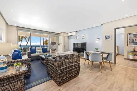 Living and dining area with oceanfront balcony