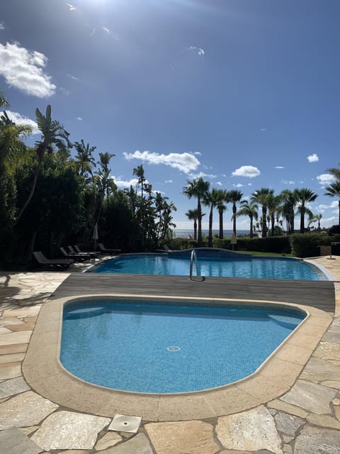 Cool off in sparkling pools framed by lush palms.