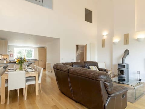 Large open plan sitting room, dining area and kitchen overlooking the lake