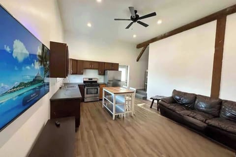 (LIVING ROOM) 55" Smart TV and electric fireplace and kitchen with stainless steel appliances. 
The hallway near the front door leads to a beautifully updated bathroom—where rustic charm meets modern comfort.