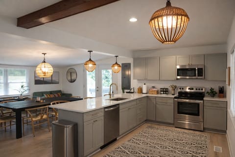 Open kitchen and dining space with modern finishes and seating.