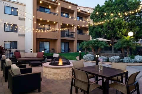 Gather under twinkling lights for cozy firepit evenings outdoors.