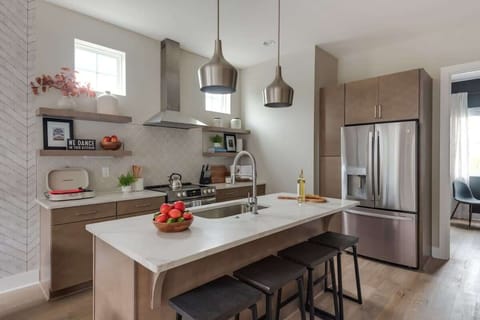 Clean and Spacious Kitchen with Sleek Countertops and Additional Seating