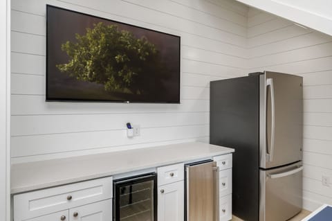 1st floor bar area with beverage center, ice maker, and full fridge