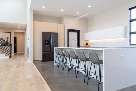 An extensive waterfall kitchen island with lots of seating
