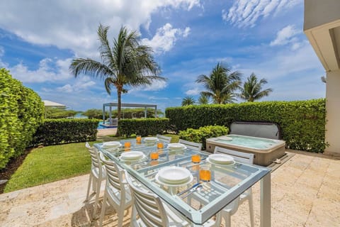 Your private patio features alfresco dining under swaying palms and a bubbling hot tub where you can unwind while soaking in stunning sea views and tropical breezes.