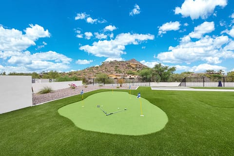 Putting green & turf area next to the pool & spa w/ amazing mountain views