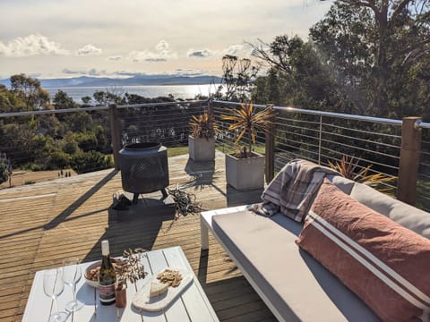 Recline on the outdoor lounges and take in the view back to mainland Tasmania