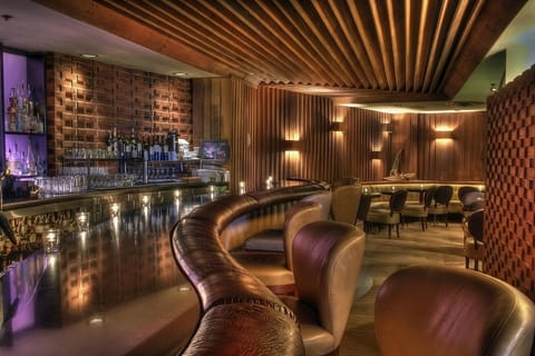 Gather with friends along curved banquettes for late-night drinks.