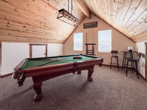 Loft game room with a pool table—perfect for friendly competition and relaxed fun.