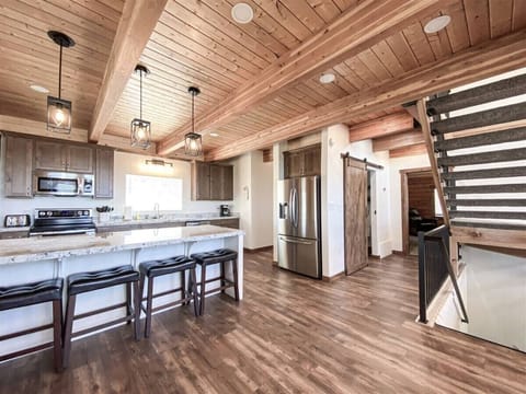 Rustic elegance meets modern comfort in this spacious, well-equipped kitchen perfect for family gatherings.
