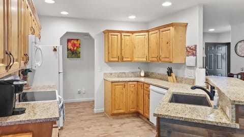 Spacious kitchen with over, refrigerator, and dishwasher