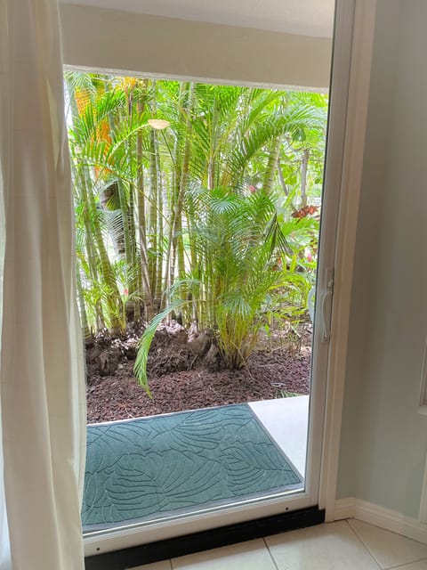 Private lanai with seating and living privacy fence.