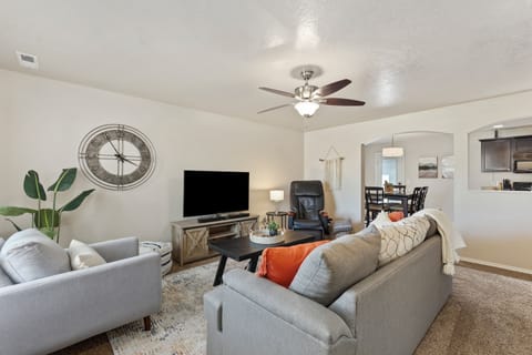 The living room boasts a 55" TV with Roku, a soothing massage chair, and plush seating for the ultimate relaxation experience. Perfect for a movie night in!  