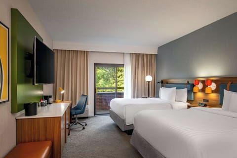 Unwind in crisp beds with soothing light and balcony view