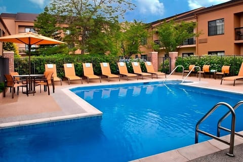 Dive into sunny afternoons by the sparkling outdoor pool.