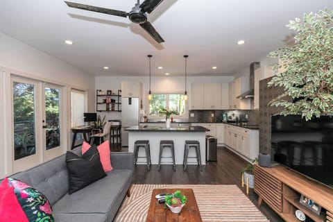 Functional open layout featuring the living room, kitchen, and workspace all in one flowing design.