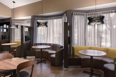 Unwind with coffee in cozy booths beside soft, sunlit windows.