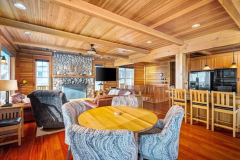 Relax together in the living room on plush leather sofas around the river rock fireplace or enjoy watching the surf from oak Morris rockers.